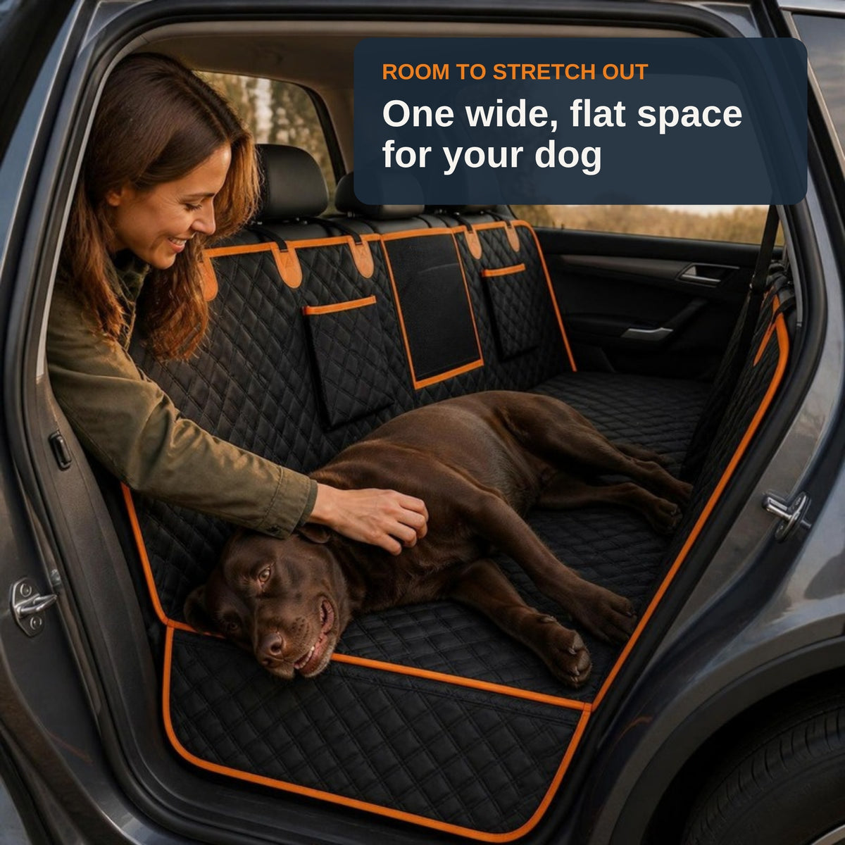 Room to stretch out: one wide, flat space for your dog. Owner petting a chocolate Labrador stretched out on the TrekFold base