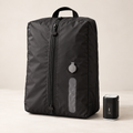 TrekFold™ compression bag standing beside its rechargeable pump